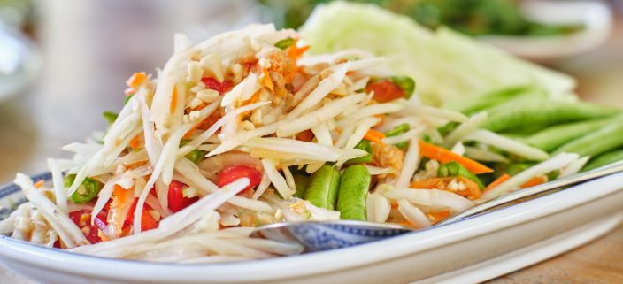 thai som tam papaya salad on table 2022 03 26 11 04 39 utc scaled