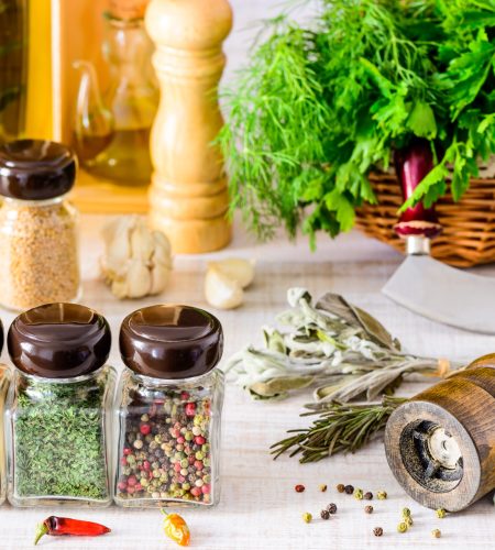 Spices, food seasoning pepper mill and green herbs. paprika, thyme and parsley